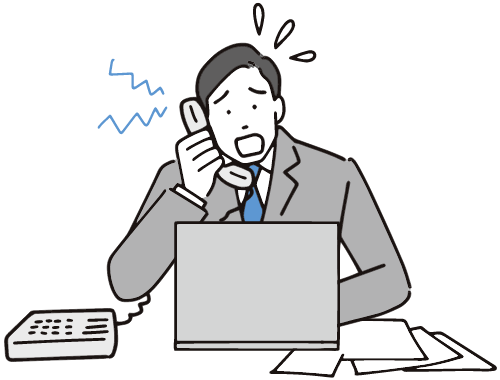 業務に追われているビジネスマン